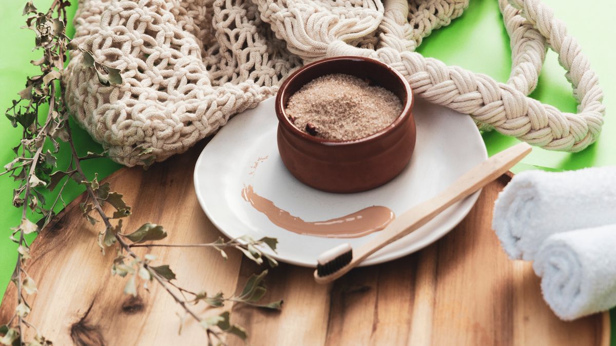 A jar of homemade coconut oil sugar scrub with sugar and coconut