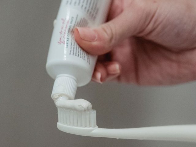 A toothbrush with natural homemade coconut oil toothpaste